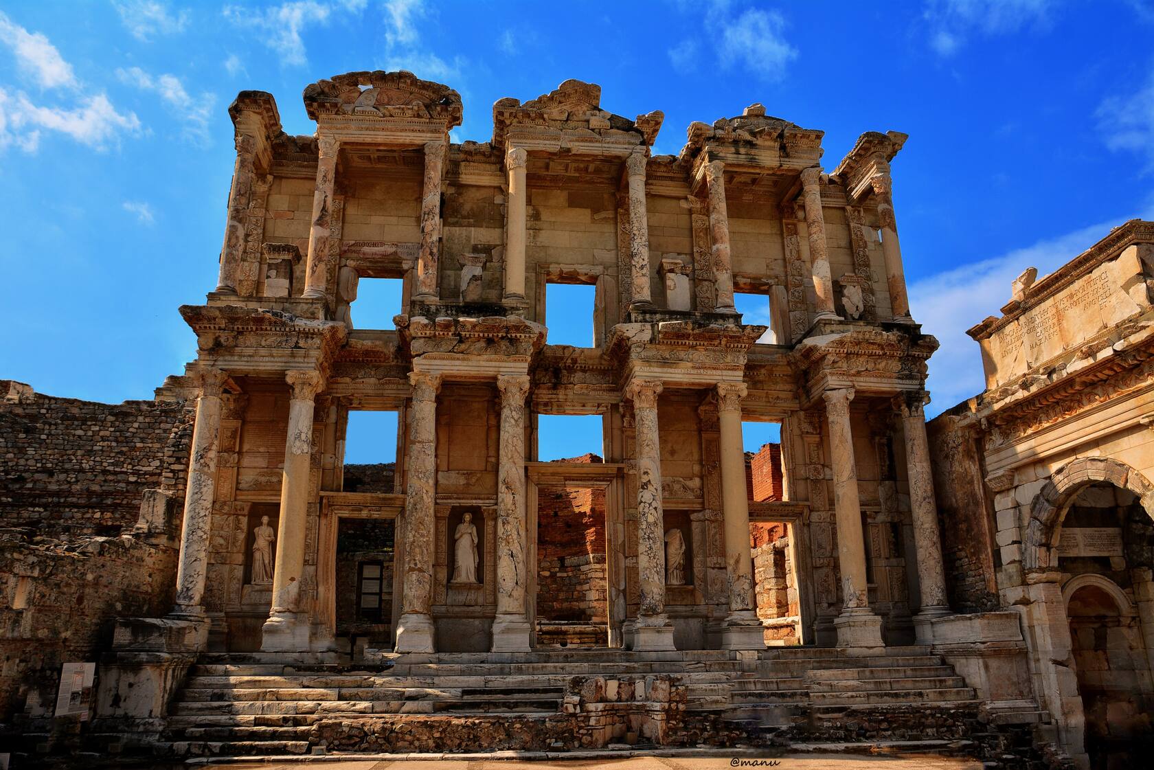 The Library of Celsus at Ephesus — a towering two-storey Roman façade in golden stone
